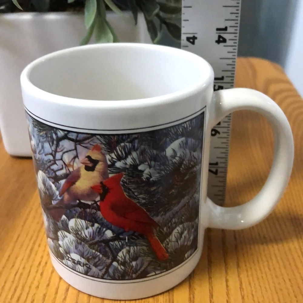Coffe cup with cardinals in winter scene